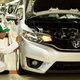 A photo of a mechanic building a Honda car.